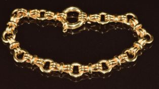 An 18k gold bracelet made up of circular and bow shaped links, 9.8g, 18cm