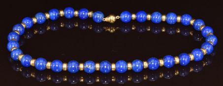 A beaded lapis lazuli necklace with 18k gold clasp and spacers, each bead approximately 10mm, 52g,