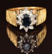 An 18ct gold ring set with a sapphire surrounded by diamonds, 6.4g, size O