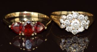 Two 9k gold rings, one set with three garnets and the other cubic zirconia, 4.2g, size N & O