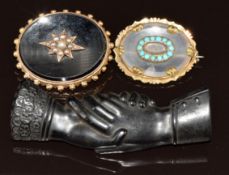 A jet brooch in the form of two hands with RD number to back and two Victorian brooches, one set