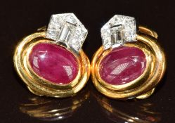 A pair of 18k gold earrings each set with a ruby cabochon of approximately 2.6ct, five round cut
