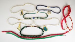 Four rock crystal necklaces with Roman glass pendants with gilt decoration, Roman beaded glass