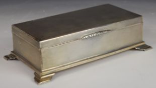 Art Deco hallmarked silver cigarette box with engine turned decoration, raised on four feet, Chester