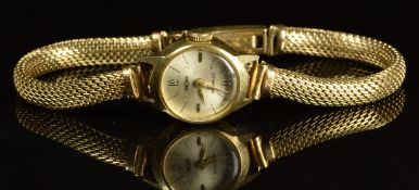 Chronex 14ct gold ladies wristwatch with gold hands, silver dial and unsigned movement, on 14ct gold