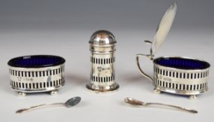 George V hallmarked silver three piece cruet set with blue glass liners, raised on squat bun feet,
