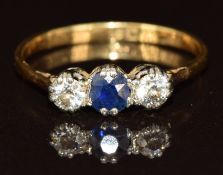 An 18ct gold ring set with a sapphire of approximately 0.2ct and two diamonds, each approximately