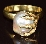 An 18k gold ring set with a pearl in a setting modelled as a claw, 5.7g, size Q