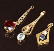 A 9ct gold pendant set with a diamond and sapphire, 9ct gold pendant set with a garnet and a 9ct