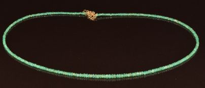 A single strand of faceted Brazilian emerald beads with 18k gold clasp, with certificate and in