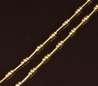An 18ct gold necklace made up of cylindrical and sphere links, 10.2g, 40cm