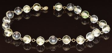 A c1920s 'pool of light' rock crystal necklace, strung as a series of rock crystal spheres mounted