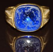 An 18k gold ring set with a synthetic sapphire, 9.6g, size U
