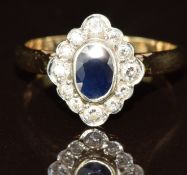 A 9ct gold ring set with an oval cut sapphire surrounded by diamonds, 3g, size L