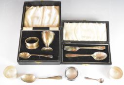 Cased hallmarked silver christening set, cased hallmarked silver spoon and fork set, three