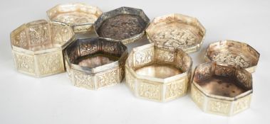 Four Chinese, Burmese or similar octagonal silver trinket pots with hinged lids, all with Chinese or