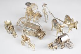 Six various Eastern silver novelty figures comprising person working two oxen, three horse drawn and