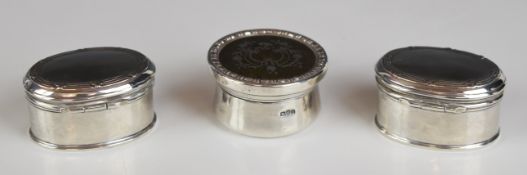 Three Edward VII or George V hallmarked silver trinket boxes comprising a pair of oval examples,