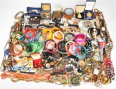 A collection of jewellery including bangles, beaded necklaces, Exquisite and other vintage brooches,