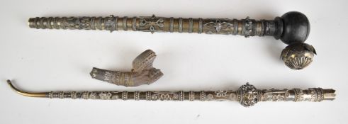 Two Chinese, Thai or similar Eastern silver mounted opium pipes, length of longer 49cm