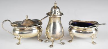 Elizabeth II hallmarked silver three piece cruet set with blue glass liners and matching spoons,