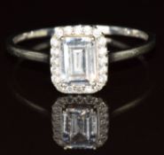 A 9ct gold ring set with goshenite surrounded by paste, 1.8g, size T