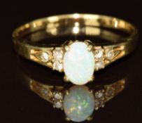 A 14k gold ring set with an opal cabochon and diamonds, 2.3g, size S