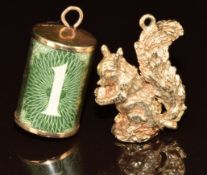 A 9ct gold charm set with a £1 note and a 9ct gold charm in the form of a squirrel