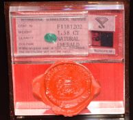 A loose 1.58ct oval cut emerald in original sealed display case