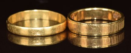 A 14k gold wedding band (3.4g, size K) and an 18k gold wedding band (1.6g, size P)