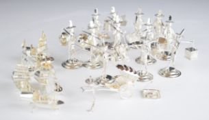 Set of twelve Eastern or similar silver place card holders formed as figures carrying goods and
