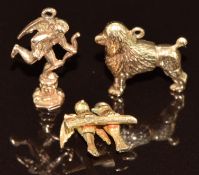 Three 9ct gold charms in the form of a poodle, two birds and Cupid, 5g