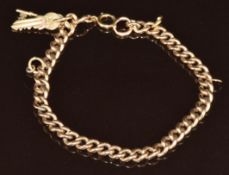 A 9ct gold curb link bracelet with a 9ct gold charm in the form of two keys, 12.6g, 18cm