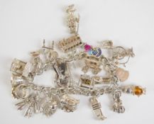 Silver charm bracelet with twenty-four silver charms including owl, bus, keys, motorbike, etc,