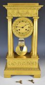 19th century French Empire style gilt metal four column mantel clock, the two train movement