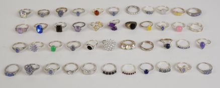 Forty four silver rings including tanzanite, opal, cubic zirconia, etc