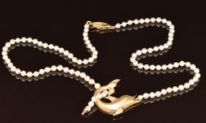 A single strand of cultured pearls with a 14k gold dolphin pendant set with cubic zirconia, 15.1g,