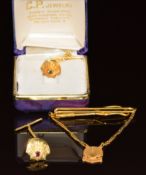 A 22k gold shell stud set with an emerald (2.6g) yellow metal shell stud set with a ruby (2.9g)