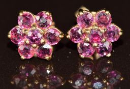 A pair of 9ct gold earrings each set with a cluster of rubies, 1.3g