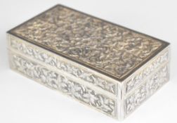 Burmese, Indian or similar silver cigarette box with embossed foliate decoration, length 12cm,