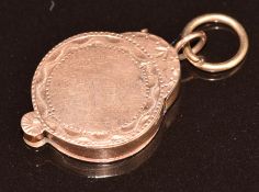 A yellow metal rose gold locket with cut out decoration, 2.9g, 2.2cm