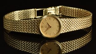 Omega 9ct gold ladies wristwatch with gold hands, baton hour markers and dial and signed quartz