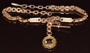 A c1900 9ct rose gold Albert / watch chain made up of faceted and rectangular links, with 9ct gold