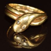 An 18ct gold c1900 ring in the form of a serpent set with rose cut diamond eyes, 5.4g, size K