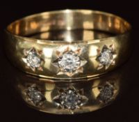 A 9ct gold ring set with three diamonds in star settings, 3.4g, size 1
