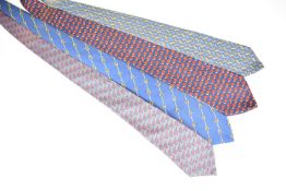 Four Hermès silk ties with jockey, horse, jockey cap and horseshoe decoration, one labelled 'The