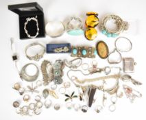 A collection of jewellery including twelve silver rings, one set with a ruby, silver bangle,