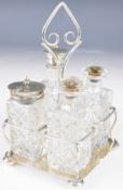 Edward VII hallmarked silver four bottle cruet stand with scroll handle and wire frame, raised on