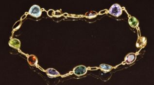 An 18k gold bracelet set with oval garnets, heart cut amethysts, heart cut aquamarines, oval cut