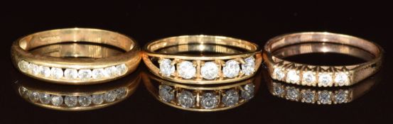Three 9ct gold rings set with cubic zirconia, 6.4g, size R, S & U